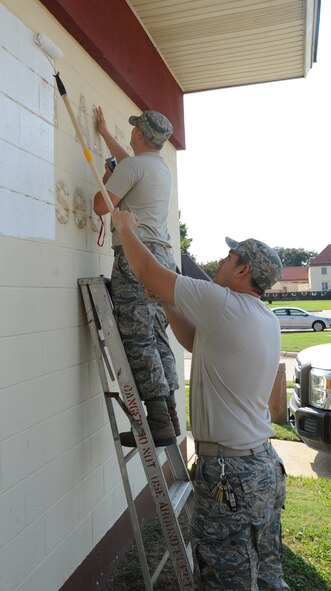 Senior Airman Steven Price (foreground) paints over remnants of the 8th Air Force Museum sign with Senior Airman James Starr, both 2nd Civil Engineer Squadron structural journeymen, on Barksdale Air Force Base, La., Sept. 24. The museum will be re-dedicated as the Barksdale Global Power Museum during a ceremony Oct. 2. (U.S. Air Force photo/Senior Airman Sean Martin)(RELEASED)