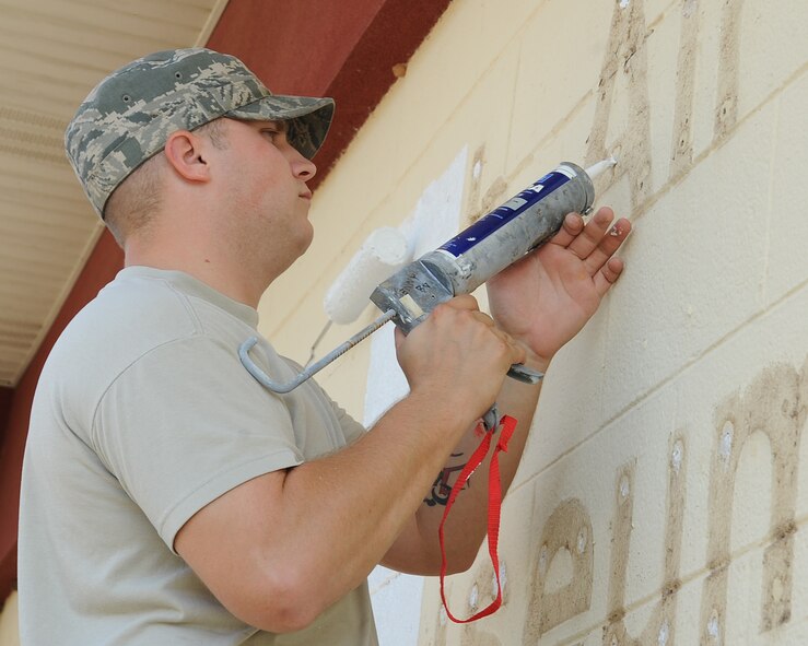 Senior Airman James Starr, 2nd Civil Engineer Squadron structural journeyman, fills holes after removing the old 8th Air Force Museum sign on Barksdale Air Force Base, La., Sept. 24. The museum will be re-dedicated as the Barksdale Global Power Museum during a ceremony Oct. 2. (U.S. Air Force photo/Senior Airman Sean Martin)(RELEASED)