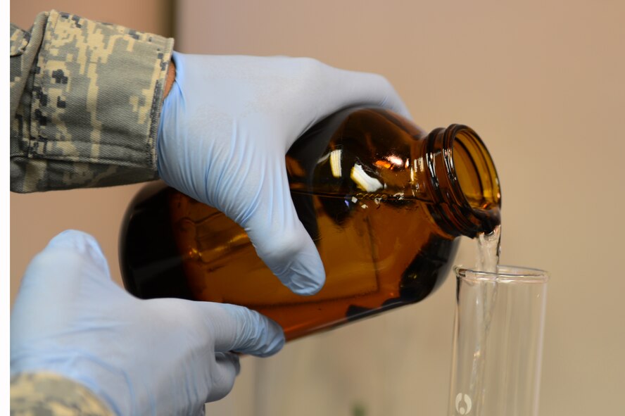 U.S. Air Force Senior Airman Megan O'Neil, 27th Special Operations Logistics Readiness Squadron fuels laboratory technician, pours a fuel sample in the fuels laboratory at Cannon Air Force Base, N.M., Sept. 4, 2012. Technicians in the fuels laboratory conducts hundreds of tests monthly to ensure quality fuel is used with Cannon's transient aircraft. (U.S. Air Force photo/Airman 1st Class Eboni Reece)