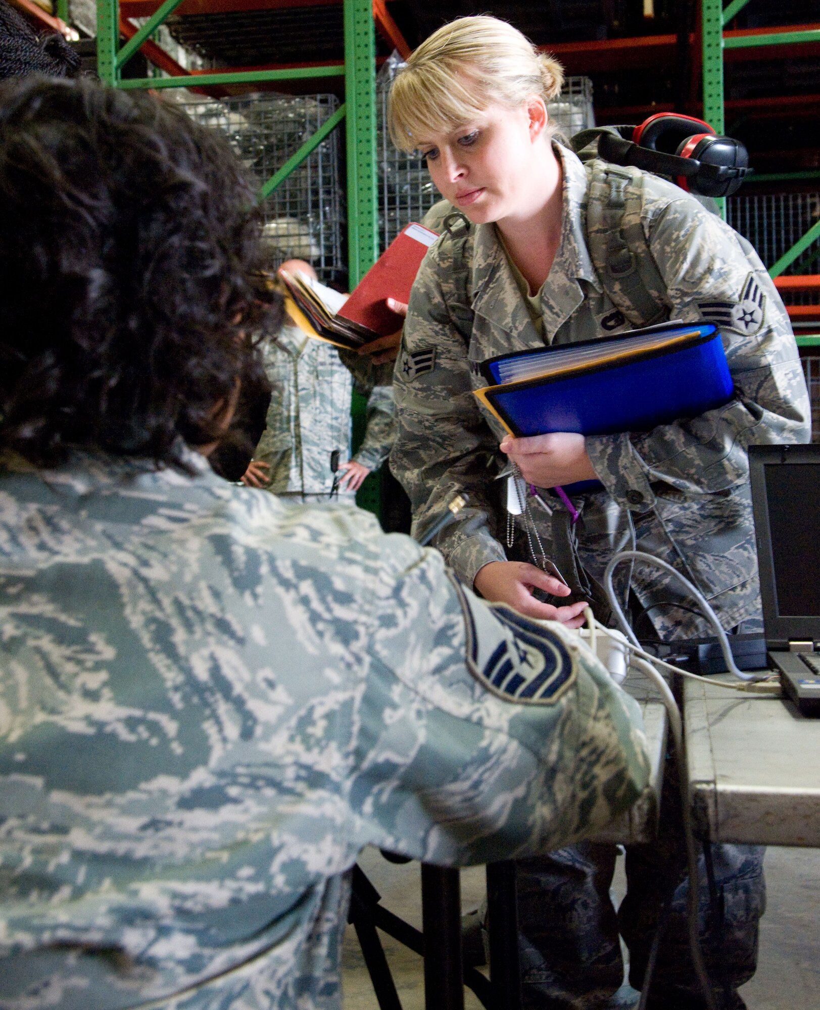 Before deploying to the Transit Center at Manas, Kyrgyz Republic, Senior Airman Cassandra Love, a 46th Aerial Port Squadron reservist, processes through a mobility line Sept. 27, 2012, on Dover Air Force Base, Del. Love is one of several aerial porters, who will be deploying for six months in support of Operation Enduring Freedom. (U.S. Air Force photo/Adrian Rowan)