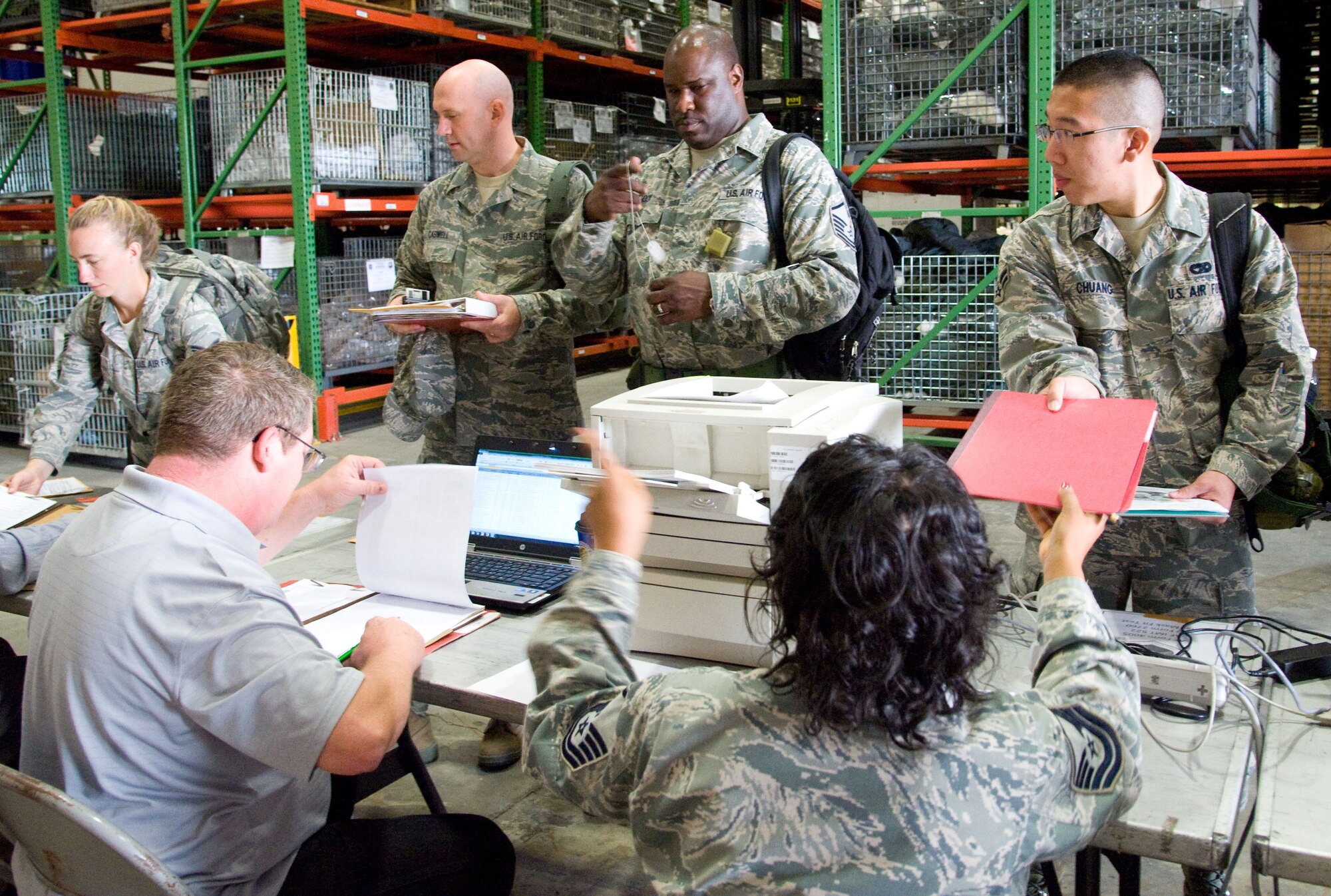 Reservists from the 512th Airlift Wing process through a mobility line Sept. 27, 2012, on Dover Air Force Base, Del., in preparation for their deployment to the Transit Center at Manas, Kyrgyz Republic. The Personnel Deployment Function ensured the team of aerial porters had required checklist items such as current weapons qualifications, training records and dog tags. (U.S. Air Force photo/Adrian Rowan)