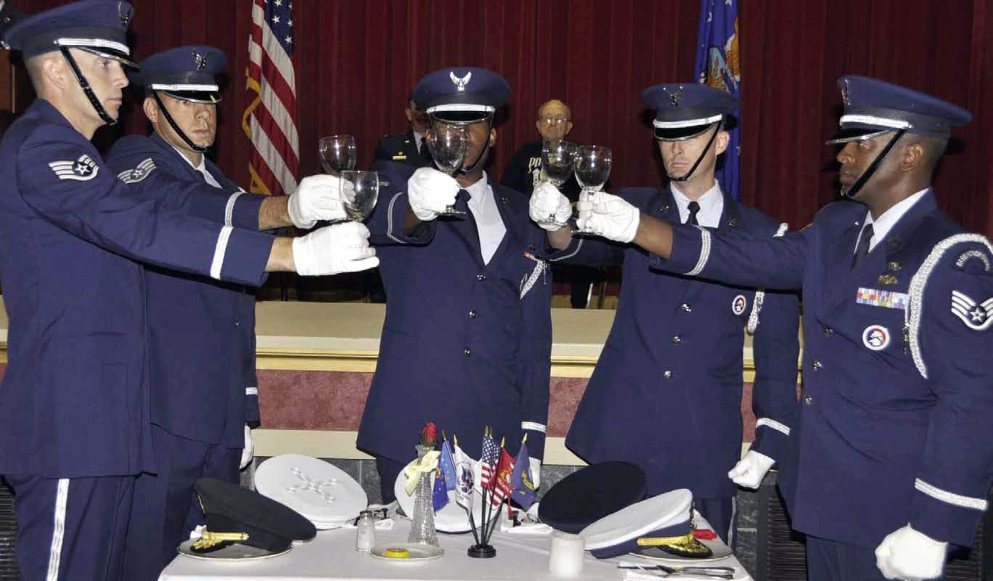 March Air Reserve Base hosted its annual POW/MIA event at the Cultural Resource Center, Sept. 21. Pictured is the March Field Blue Eagles Total Force Honor Guard performing as Cecil Davis, an American POW at Dachau, looks on. (U.S. Air Force photo by Master Sgt. Linda Welz)