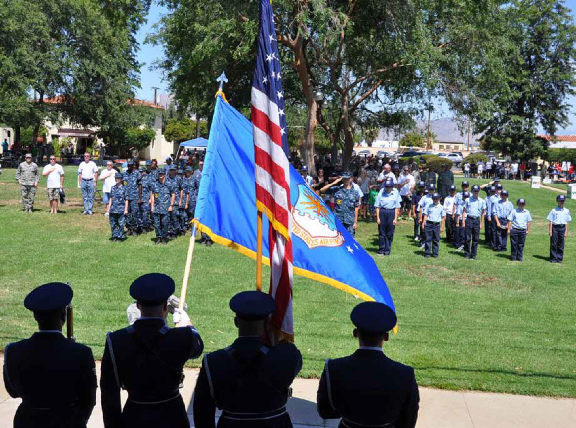 U.S. Navy Sea Cadets stand in formation as the Blue Eagles Honor Guard present the colors at the 40th-Annual Military Appreciation Picnic, March Air Reserve Base, Calif., Sept. 8, 2012. The cadets volunteered to work at the event, which is coordinated and paid for by the Greater Riverside and Moreno Valley Chambers’ Military Affairs Committees. (U.S. Air Force photo by Master Sgt. Linda Welz)