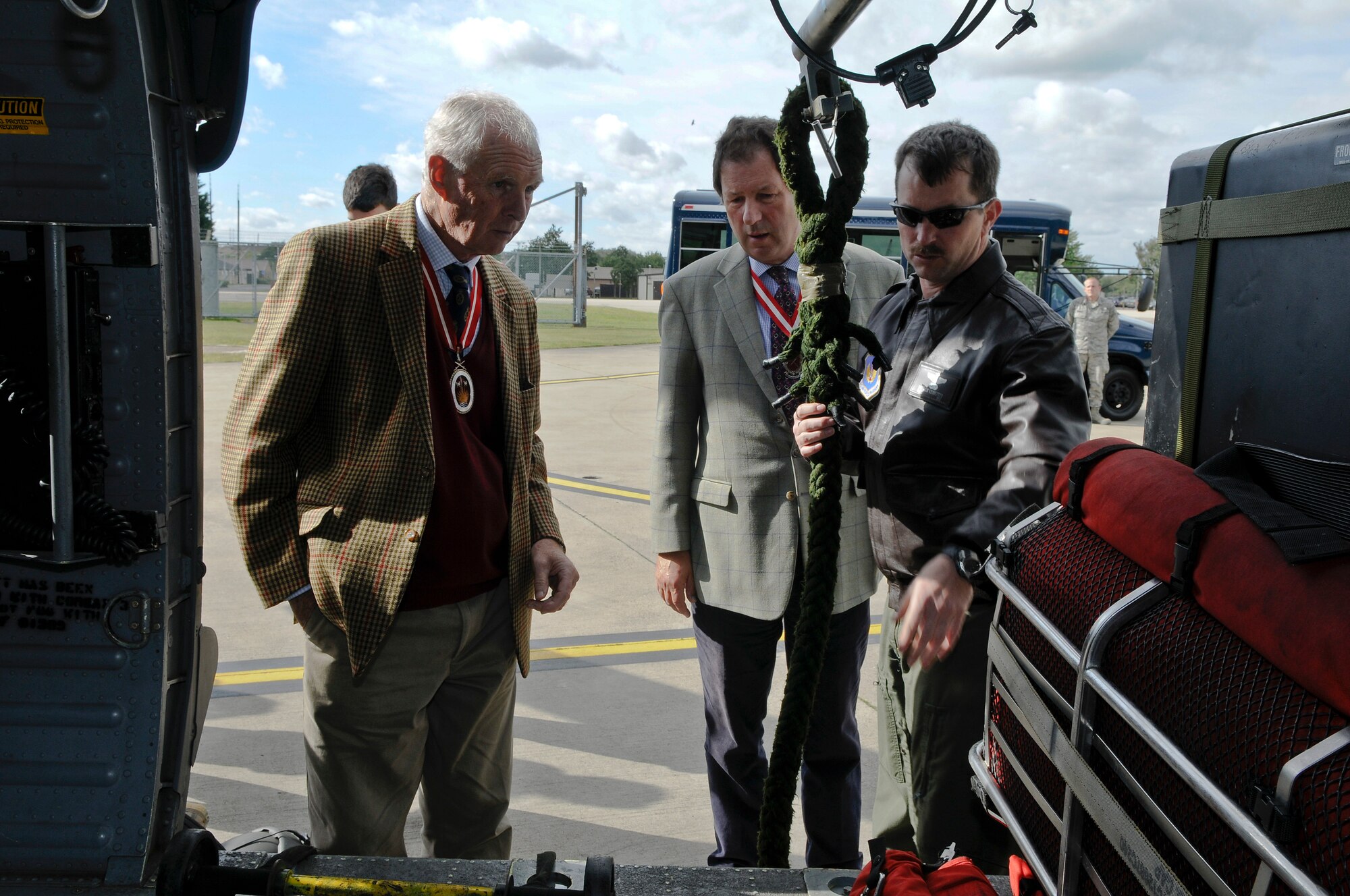 ROYAL AIR FORCE LAKENHEATH, England - Tech. Sgt. Patrick Ledbetter (right), 56th Rescue Squadron NCO in charge of training, explains different parts inside an HH-60G Pave Hawk helicopter to Henry Cator (middle), Norfolk High Sheriff and Andrew Norman-Butler, Suffolk High Sheriff, during a base visit Sept. 25, 2012. The Liberty Wing gave the High Sheriffs of Cambridgeshire, Suffolk and Norfolk, along with their spouses, tours of the 48th Maintenance Group Propulsion Facility, 48th Operations Support Squadron, static aircraft displays and other locations to continue building partnership capacities with local community leaders.  A High Sheriff is the appointed representative of the English sovereign who oversees judiciary matters and ensures law and order. (U.S. Air Force photo by Senior Airman Connor Estes)