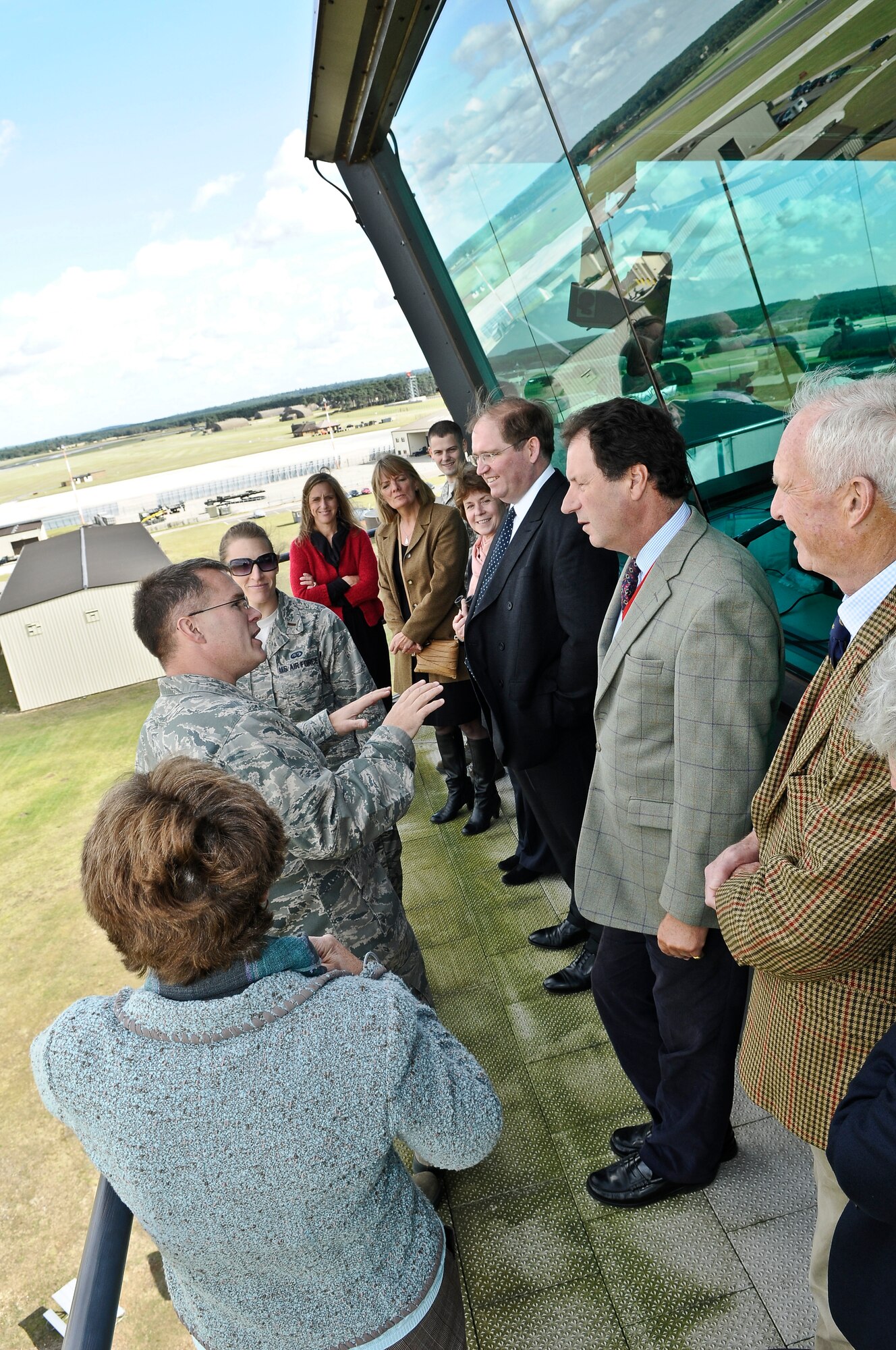 ROYAL AIR FORCE LAKENHEATH, England - Col. Mark Ciero (left/middle), 48th Fighter Wing vice commander, explains airfield operations to Henry Cator (right/middle), Norfolk High Sheriff, at the air traffic control tower during a base visit Sept. 25, 2012. The Liberty Wing gave the High Sheriffs of Cambridgeshire, Suffolk and Norfolk, along with their spouses, tours of the 48th Maintenance Group Propulsion Facility, 48th Operations Support Squadron, static aircraft displays and other locations to continue building partnership capacities with local community leaders.  A High Sheriff is the appointed representative of the English sovereign who oversees judiciary matters and ensures law and order. (U.S. Air Force photo by Senior Airman Connor Estes)