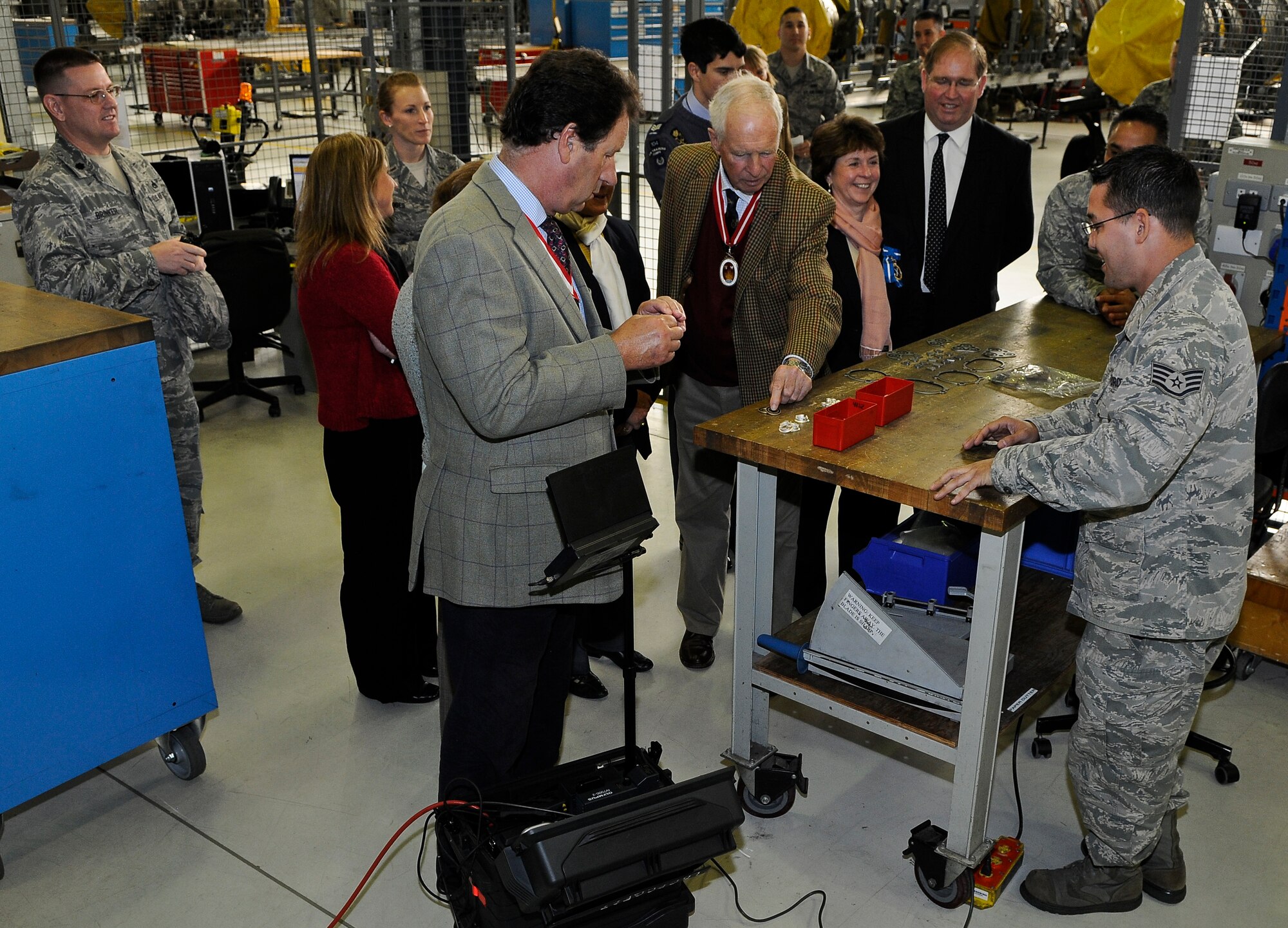 ROYAL AIR FORCE LAKENHEATH, England - Staff Sgt. Timothy Cowdell (right), 48th Component Maintenance Squadron aerospace propulsion craftsman, shows different parts and seals to the high sheriffs tour group inside the 48th CMS Propulsion Facility, during a base visit Sept. 25, 2012. The Liberty Wing gave the High Sheriffs of Cambridgeshire, Suffolk and Norfolk, along with their spouses, tours of the 48th Maintenance Group Propulsion Facility, 48th Operations Support Squadron, static aircraft displays and other locations to continue building partnership capacities with local community leaders.  A High Sheriff is the appointed representative of the English sovereign who oversees judiciary matters and ensures law and order. (U.S. Air Force photo by Senior Airman Connor Estes)