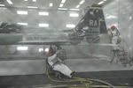 Corn Starch fills the air as John Esquivel (left), and Daniel Perez, 12th Flying Training Wing Maintenance Division media blast technicians, use corn starch to strip the paint from a T-38 Talon at Joint Base San Antonio-Randolph, Sept. 20. Two materials 12th FTW shops air blast to remove paint from T-1, T-6, T-38 and F-16 aircraft are plastic and corn starch, which have been deemed environmentally safe by the Air Force. Randolph generates about 20,000 pounds of plastic and 28,500 pounds of corn starch annually that is recycled.  The excess plastic is shipped to Canton, Ohio, where it is manufactured into products such as simulated marble tiles and dog bowls.
 (U.S. Air Force photo by Rich McFadden) 