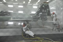 Corn Starch fills the air as John Esquivel (left), and Daniel Perez, 12th Flying Training Wing Maintenance Division media blast technicians, use corn starch to strip the paint from a T-38 Talon at Joint Base San Antonio-Randolph, Sept. 20. Two materials 12th FTW shops air blast to remove paint from T-1, T-6, T-38 and F-16 aircraft are plastic and corn starch, which have been deemed environmentally safe by the Air Force. Randolph generates about 20,000 pounds of plastic and 28,500 pounds of corn starch annually that is recycled.  The excess plastic is shipped to Canton, Ohio, where it is manufactured into products such as simulated marble tiles and dog bowls.
 (U.S. Air Force photo by Rich McFadden) 