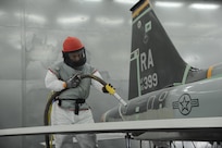 Louis Gonzales, 12th Flying Training Wing Maintenance Division media blast technicians, prepare to use use corn starch to strip the paint from a T-38 Talon at Joint Base San Antonio-Randolph, Sept. 20. Two materials 12th FTW shops air blast to remove paint from T-1, T-6, T-38 and F-16 aircraft are plastic and corn starch, which have been deemed environmentally safe by the Air Force. Randolph generates about 20,000 pounds of plastic and 28,500 pounds of corn starch annually that is recycled.  The excess plastic is shipped to Canton, Ohio, where it is manufactured into products such as simulated marble tiles and dog bowls.  (U.S. Air Force photo by Rich McFadden) 