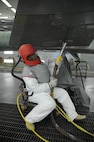John Esquivel, 12th Flying Training Wing Maintenance Division media blast technician, prepares to use corn starch to strip the paint from a T-38 Talon at Joint Base San Antonio-Randolph, Sept. 20.  Two materials 12th FTW shops air blast to remove paint from T-1, T-6, T-38 and F-16 aircraft are plastic and corn starch, which have been deemed environmentally safe by the Air Force.
Randolph generates about 20,000 pounds of plastic and 28,500 pounds of corn starch annually that is recycled.  The excess plastic is shipped to Canton, Ohio, where it is manufactured into products such as simulated marble tiles and dog bowls.  (U.S. Air Force photo by Rich McFadden) 