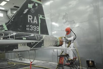 Daniel Perez, 12th Flying Training Wing Maintenance Division media blast technician, prepares to use corn starch to strip the paint from a T-38 Talon at Joint Base San Antonio-Randolph, Sept. 20.  Two materials 12th FTW shops air blast to remove paint from T-1, T-6, T-38 and F-16 aircraft are plastic and corn starch, which have been deemed environmentally safe by the Air Force.
Randolph generates about 20,000 pounds of plastic and 28,500 pounds of corn starch annually that is recycled.  The excess plastic is shipped to Canton, Ohio, where it is manufactured into products such as simulated marble tiles and dog bowls. (U.S. Air Force photo by Rich McFadden) 