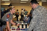 Texas Department of Public Safety Cpl. Arminda Henke meets with
members of the armed forces like Sgt. 1st Class Christian Garcia at
the Hiring Heroes Career Fair Sept. 18. Veterans and retirees make
up 60 percent of the DPS force, according to Henke.  Photo by Deyanira Romo Rossell