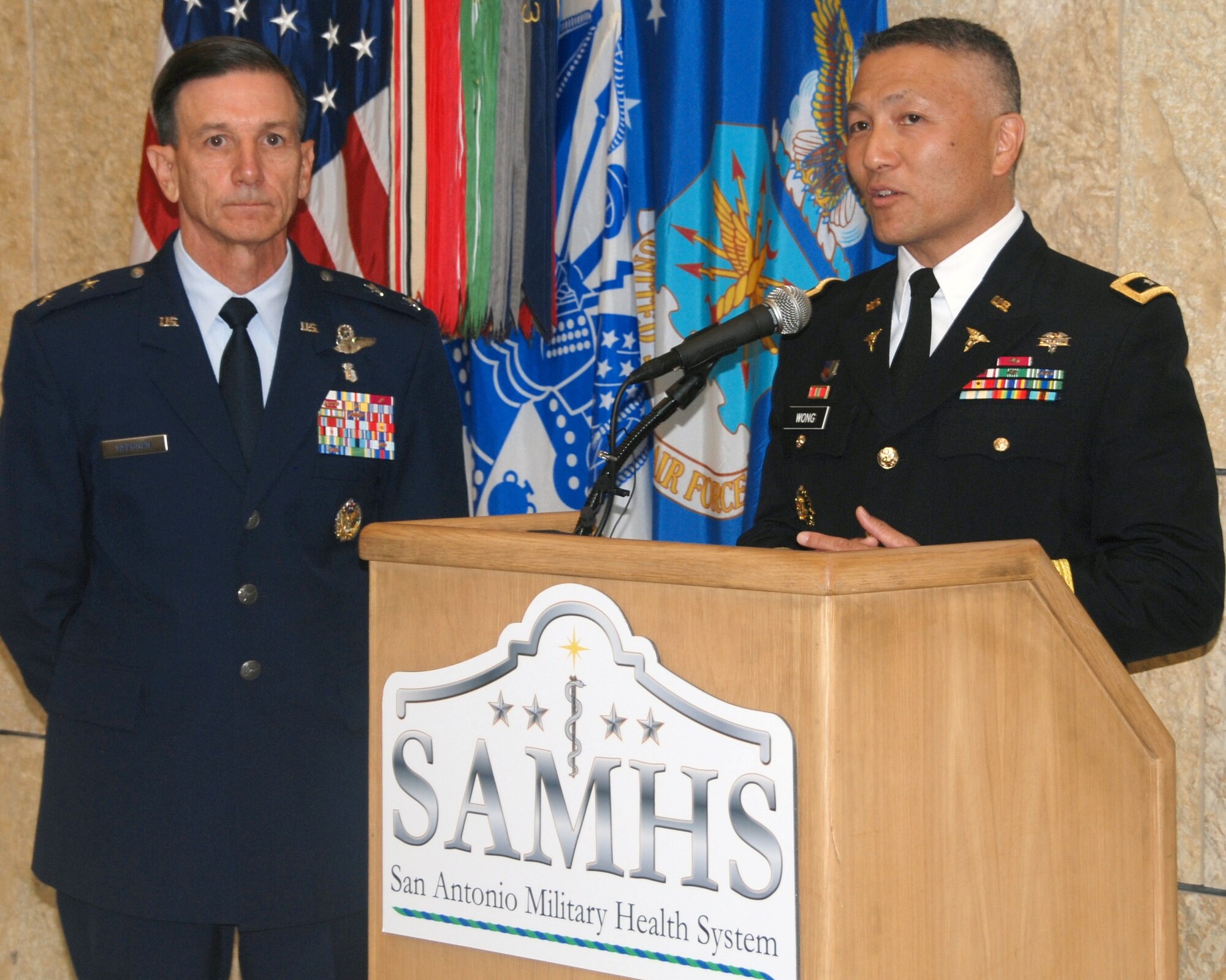 U.S. Air Force Maj. Gen. Byron Hepburn and Army Maj. Gen. M. Ted Wong
speak during the San Antonio Military Health System one-year anniversary at
the San Antonio Military Medical Center Sept. 14. Hepburn is the SAMHS
director and the 59th Medical Wing commander. Wong is the SAMHS deputy
director and Brooke Army Medical Center commander. Photo by Staff Sgt. Corey Hook