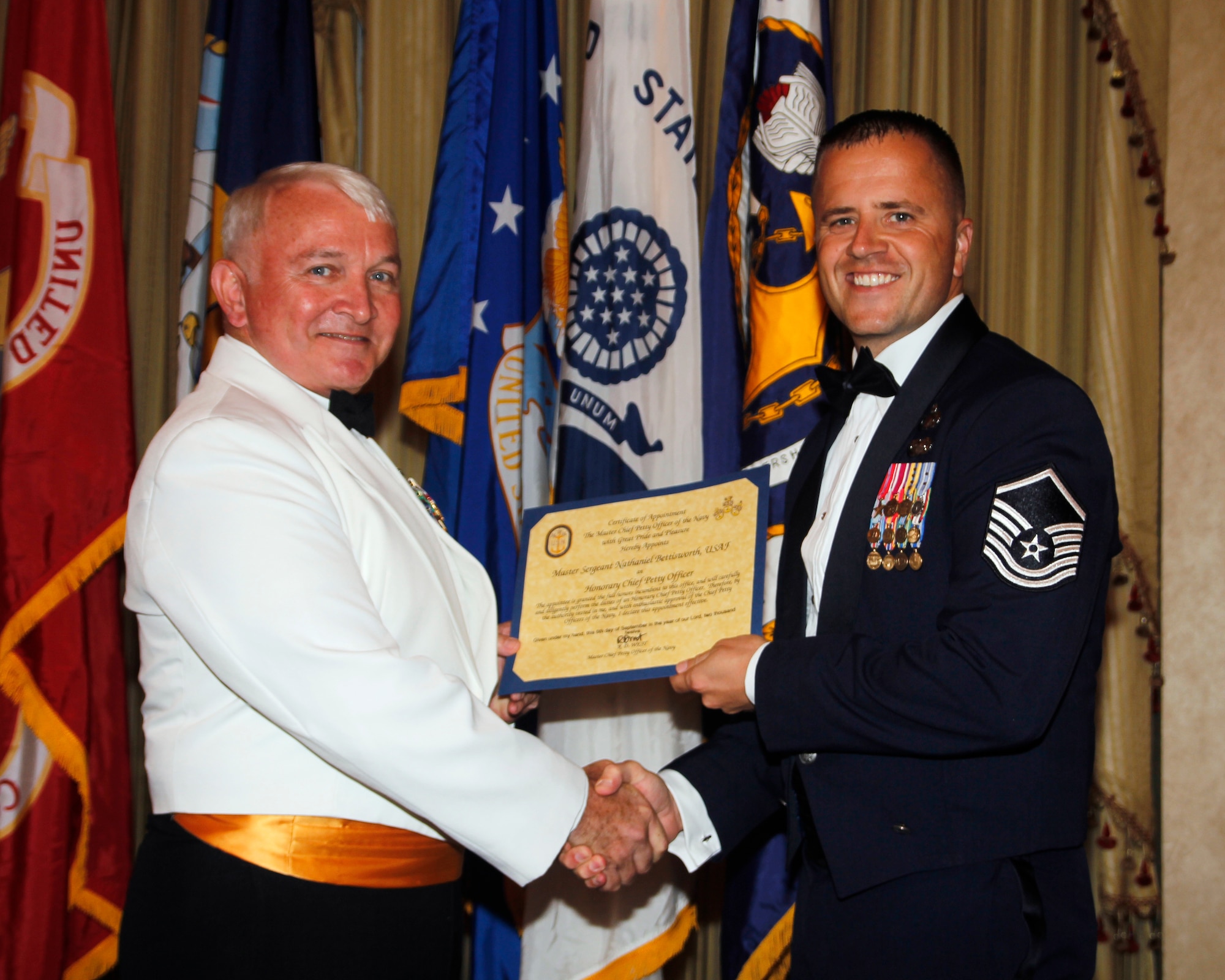 Master Sgt. Nate Bettisworth, U.S. Air Force Air Demonstration Squadron "Thunderbirds," receives honors from U.S. Navy Command Master Chief Charles Dassance, Navy Senior Enlisted Academy director, during the Naval Senior Enlisted Academy graduation Sept. 6, 2012, in Newport, R.I. Bettisworth was able to apply and get accepted into the Naval SEA with a letter of recomendation. In his class of 92 students, four were Air Force. (Courtesy Photo)
