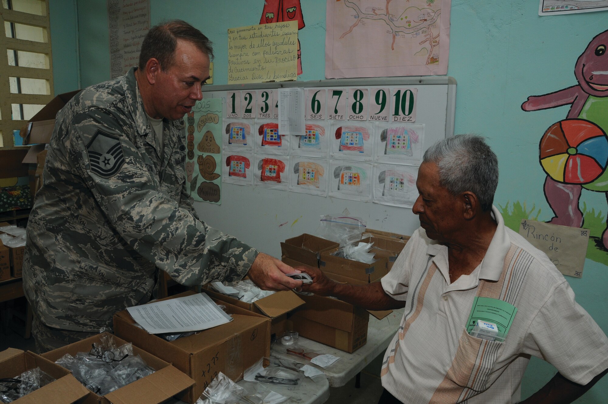 WRIGHT-PATTERSON AIR FORCE BASE, Ohio - Master Sgt. Michael Telford, 445th Airlift Wing Aerospace Medicine Squadron optometry services NCO in charge, issues a pair of glasses to a patient in Laventa Village, Coclé Province, Panama, Aug. 23, 2012. Thirty members from the 445th Airlift Wing descended upon Panama for the Panama Medical Readiness Training Exercise Aug. 18-31, providing medical services to 5,000 residents who have little or no access to medical care. (U.S. Air Force photo/Tech. Sgt. Anthony G. Springer)

