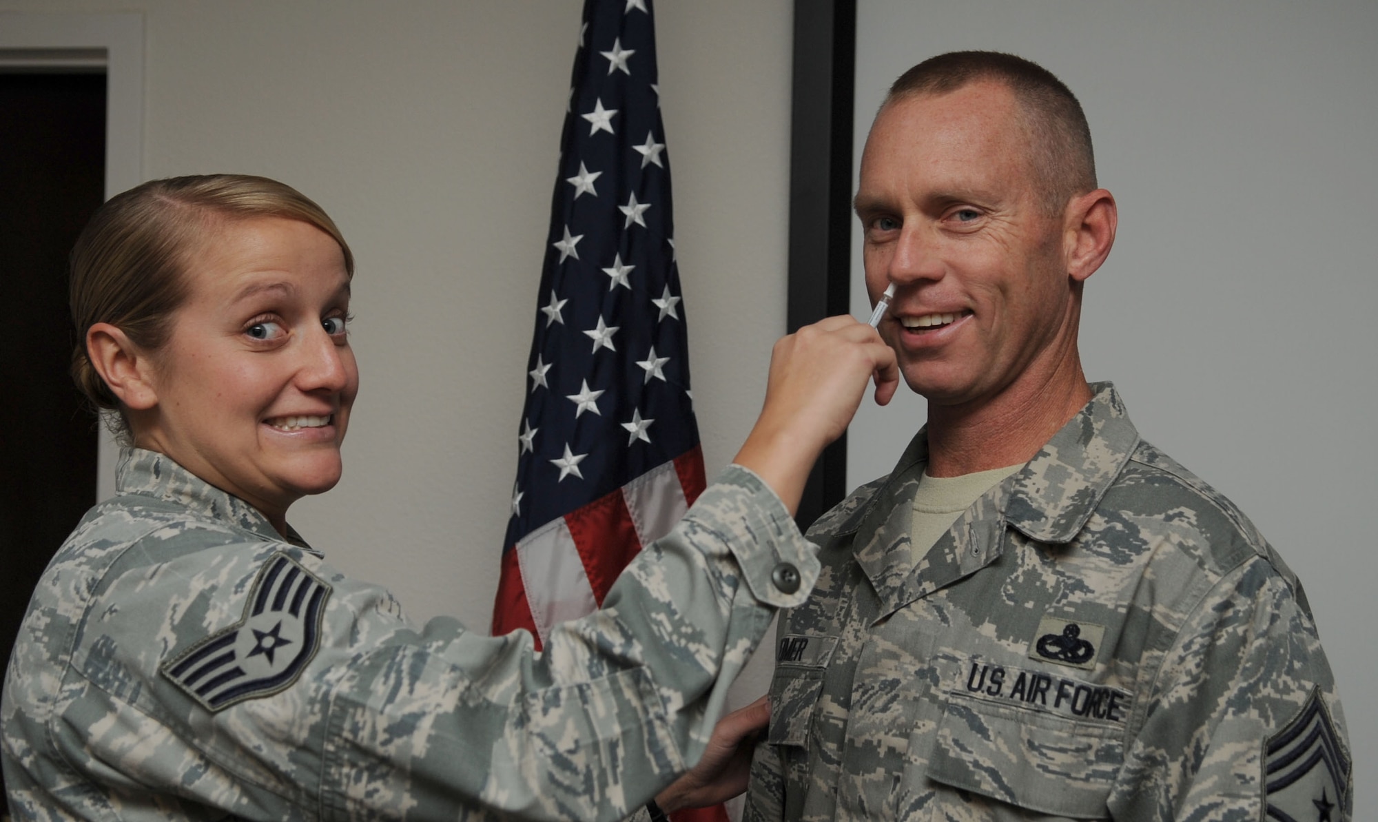 U.S. Air Force Staff Sgt. Nicole Olive, 366th Medical Group medical technician, administers the flu vaccine to Chief Master Sgt. Geoff Weimer, 366th Fighter Wing command chief, Sep. 26, 2012, at Mountain Home Air Force Base, Idaho. Before receiving the vaccination, each individual is required to review a series of questions to help establish the best way it will be administered. (U.S. Air Force photo/Airman 1st Class Shane M. Phipps)