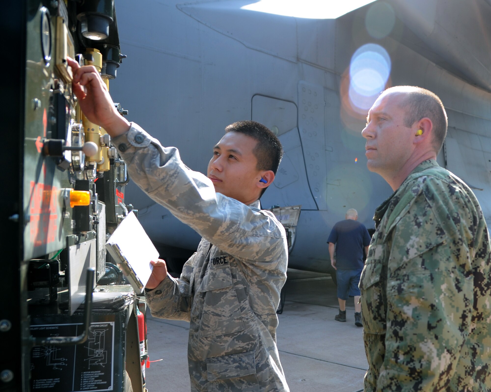 ALTUS AIR FORCE BASE, Okla. – Senior Airman Jimmy Dang, 97th Logistics Readiness Squadron fuels equipment operator, shows Navy Petty Officer 1st Class Johnny Sweetin, Navy Operational Support Center Reserve Battalion hull technician, how to record amounts of fuel at the flight line, Sept. 19, 2012. The 97th LRS Fuels Management Flight provided Air Force specific refueling equipment training to four Navy Petty Officers Sept. 10-21. The training included issue and accountability using the Automated Point of Sale Device and certain aspects of fuels facility and bulk storage stand operations. (U.S. Air Force photo by Airman 1st Class Klynne Pearl Serrano / Released)