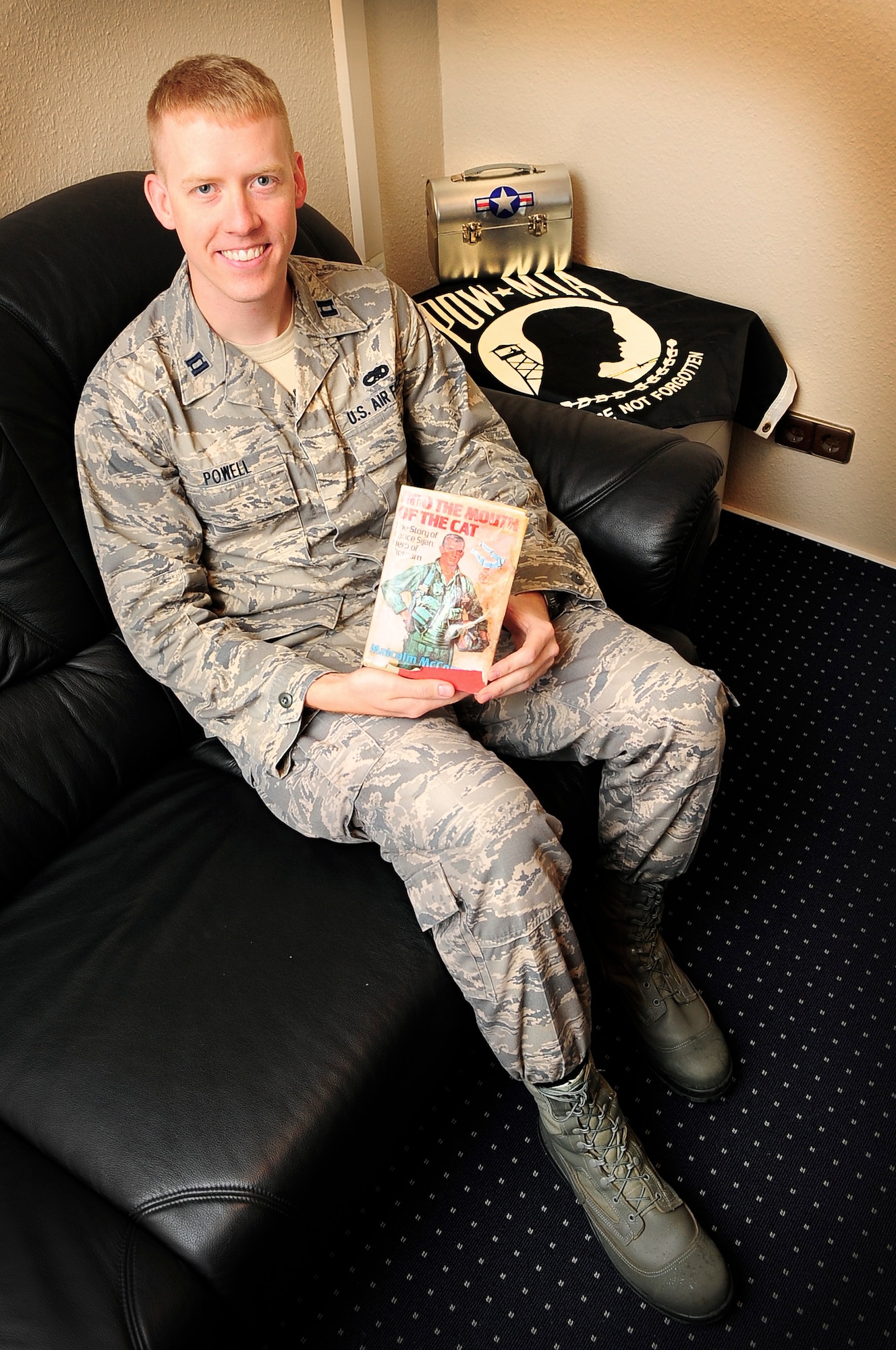 Capt. Jason Powell, 435th Contingency Response Group operations officer, received a first-edition copy of "Into the Mouth of the Cat," when he was 13 years old. The book, which tells the story of Capt. Lance P. Sijan, inspired him to become an officer in the U.S. Air Force. Powell met the man who helped tell this story, retired Capt. Guy Gruters, during a POW/MIA event held at Ramstein Air Base Sept. 21. (U.S. Air Force photo/Tech. Sgt. Tyrona Lawson)
