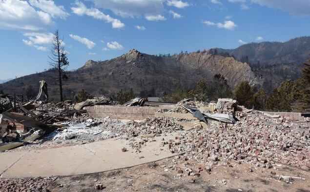 Looking from the front of the house to the canyon beyond, Senior Airman Jason Williamson captures the complete destruction of his family’s home, located in the Mountain Shadows neighborhood of northwest Colorado Springs. (Senior Airman Jason Williamson)
