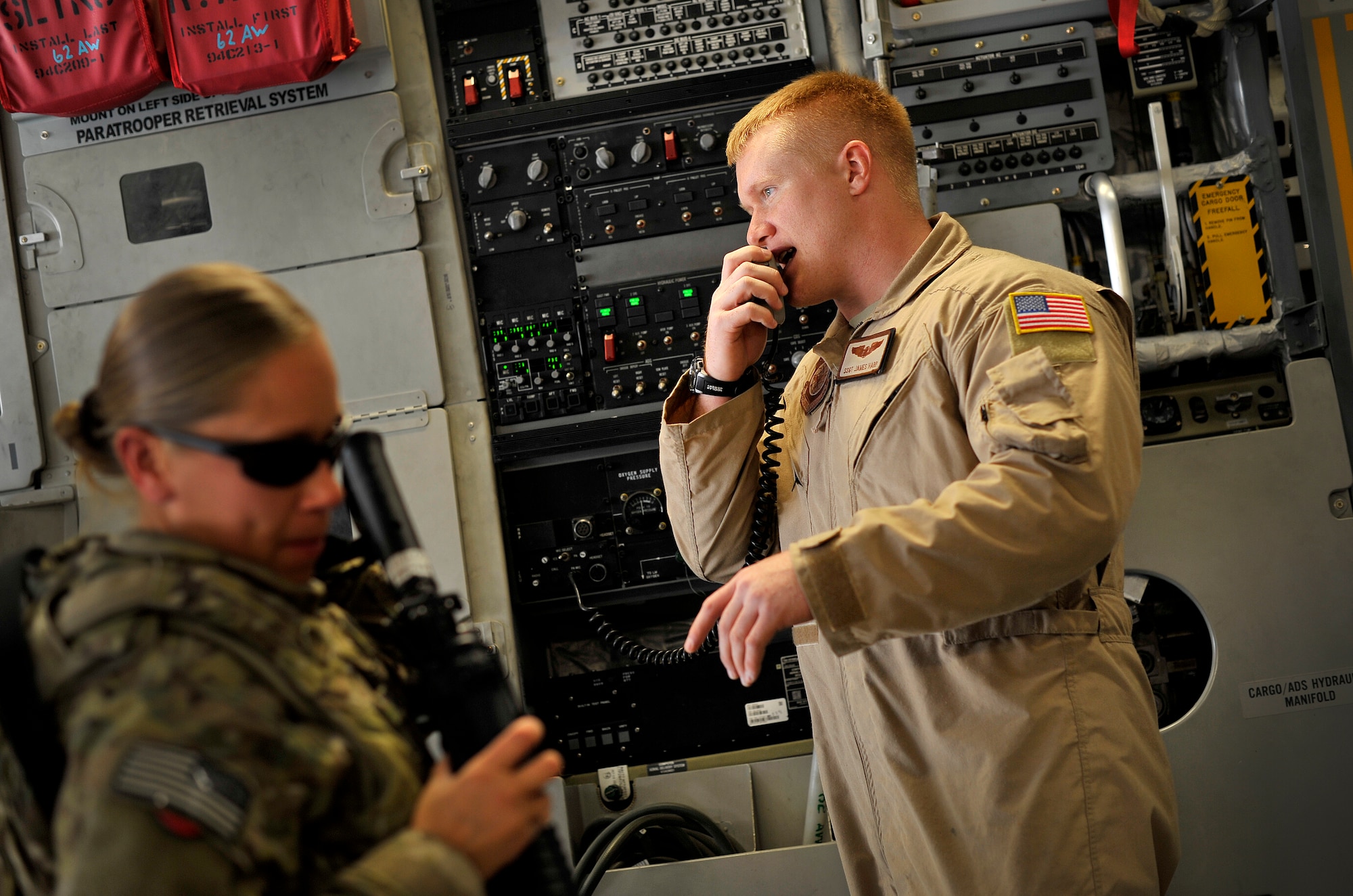 U.S. Air Force Staff Sgt. James Harp, C-17 Globemaster III loadmaster, gives instructions to passengers during a redeployment mission headed for Afghanistan, Sept. 15, 2012. Sgt. Harp is currently part of the 817th Expeditionary Airlift Squadron, deployed to the Transit Center at Manas, Kyrgyzstan. The 817th and their C-17s are an integral piece of the redeployment mission and help to move passengers and cargo within the area of operation. 