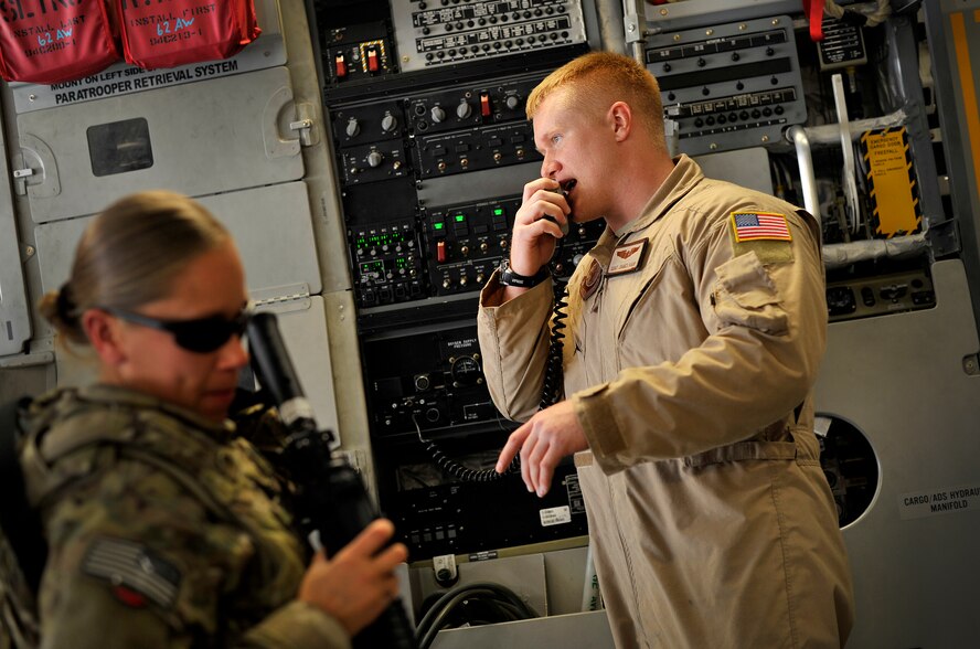 Staff Sgt. James Harp, C-17 Globemaster III loadmaster, gives instructions to passengers during a redeployment mission headed for Afghanistan, Sept. 15, 2012. Harp is currently part of the 817th Expeditionary Airlift Squadron, deployed to the Transit Center at Manas, Kyrgyzstan. The 817th and their C-17s are an integral piece of the redeployment mission and help to move passengers and cargo within the area of operation. (U.S. Air Force photo/Staff Sgt. Clay Lancaster)

