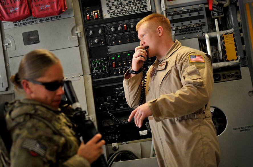 U.S. Air Force Staff Sgt. James Harp, C-17 Globemaster III loadmaster, gives instructions to passengers during a redeployment mission headed for Afghanistan, Sept. 15, 2012. Sgt. Harp is currently part of the 817th Expeditionary Airlift Squadron, deployed to the Transit Center at Manas, Kyrgyzstan. The 817th and their C-17s are an integral piece of the redeployment mission and help to move passengers and cargo within the area of operation. 