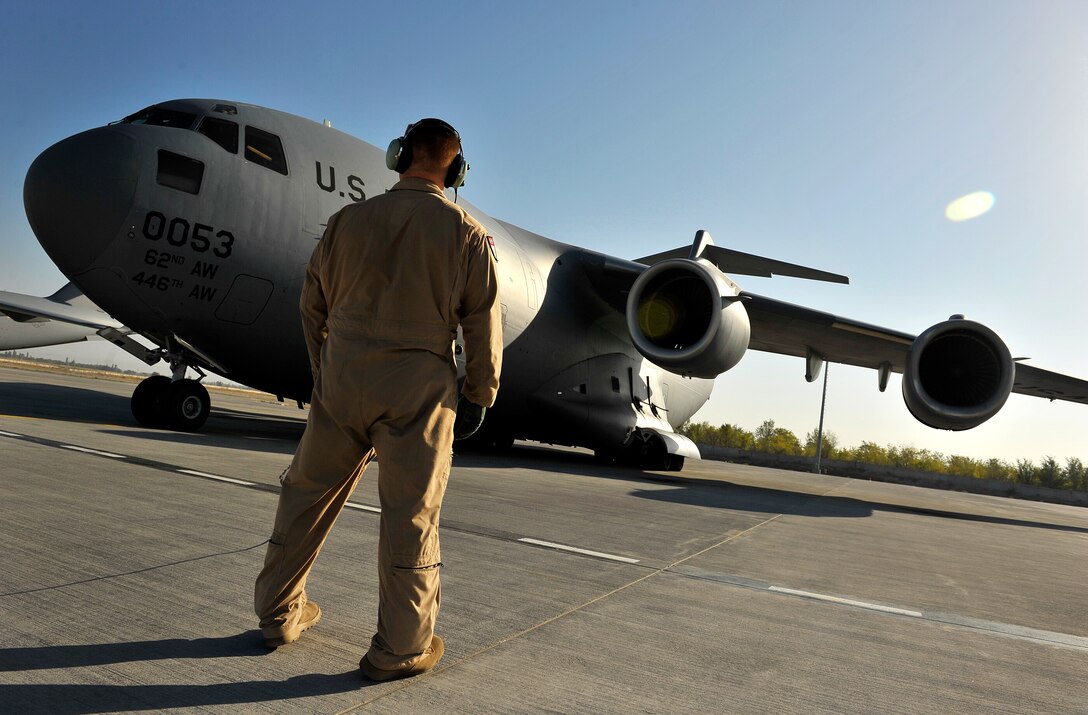 U.S. Air Force Staff Sgt. James Harp, C-17 Globemaster III Loadmaster, performs engine start-up procedures with the onboard crew during a redeployment mission headed for Afghanistan, Sept. 11, 2012. Sgt. Harp is currently part of the 817th Expeditionary Airlift Squadron, deployed to the Transit Center at Manas, Kyrgyzstan. The 817th and their C-17s are an integral piece of the redeployment mission and help to move cargo within the AOR and transport passengers during redeployment missions. (U.S. Air Force photo/Staff Sgt. Clay Lancaster/Released)