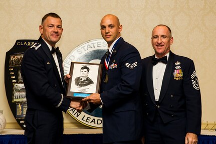 Col. Richard McComb, Joint Base Charleston commander and Chief Master Sgt. Earl Hannon, 628th Air Base Wing command chief, present Senior Airman Devon Brown, 437th Maintenance Squadron aerospace ground equipment journeyman, the John Levitow Award during the Airman Leadership School Class 2012 – G graduation ceremony Sept. 20, 2012 at JB Charleston - Air Base, S.C. The Levitow Award is awarded for a student's exemplary demonstration of excellence, both as a leader and scholar.  (U.S. Air Force photo/Airman 1st Class George Goslin)