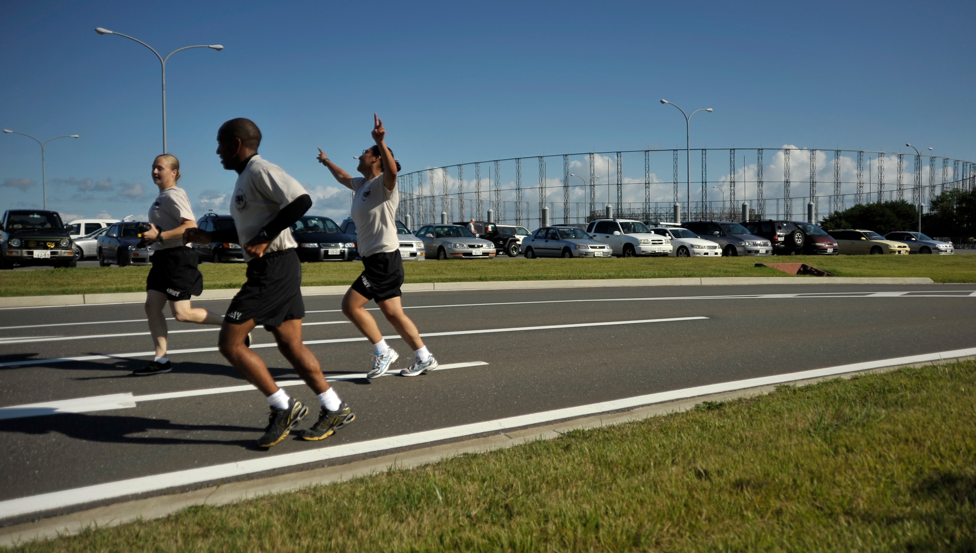U.S. Army Spc. Moana Balraj celebrates as she reaches the end of the first Chief Warrant Officer 4 Brian Lawter Memorial Run alongside Staff Sgt. Emily Fannin, back left, and Capt. Jason Quash, front center, all of whom are members of the 708th Military Intelligence Detachment, at Misawa Air Base, Japan, Sept. 26, 2012. More than 150 Soldiers, Sailors, Airmen and civilians gathered at Reese Road to tackle the twelve-mile run to pay tribute to Lawter’s legacy. (U.S. Air Force photo by Staff Sgt. Nathan Lipscomb)