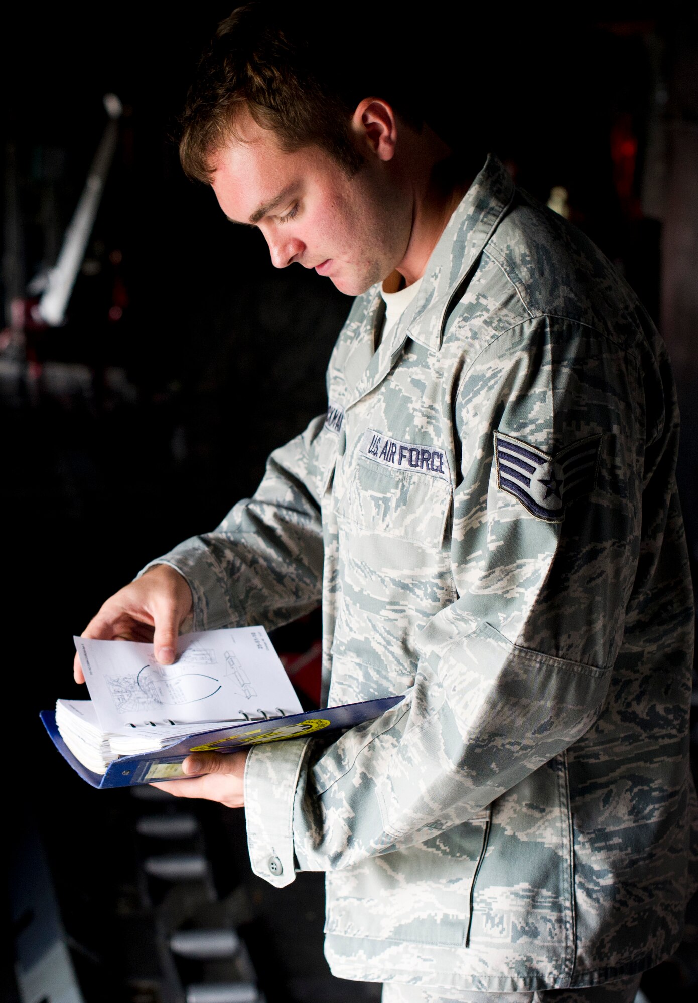 YOKOTA AIR BASE, Japan -- Staff Sgt. Luke Hickman, 374th Aircraft Maintenance Squadron, uses a Job Guide to prepare his team for the cargo rail removal Sept. 25, 2012, at Yokota Air Base, Japan.  All maintenance is performed in accordance with written technical publications. (U.S. Air Force Photo by Staff Sgt. Stacy Moless)