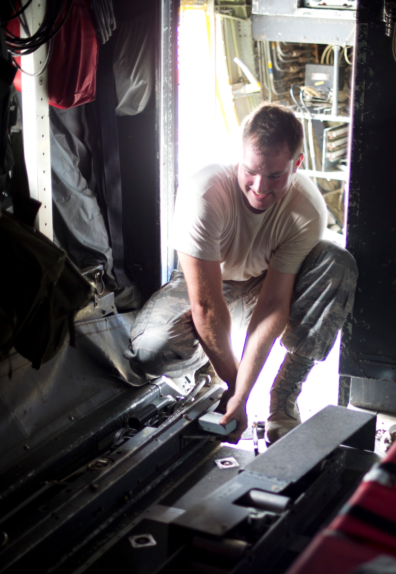 YOKOTA AIR BASE, Japan -- Staff Sgt. Luke Hickman 374th Aircraft Maintenance Squadron, lifts and slides one of the rail sections out of a C-130 Hercules aircraft Sept. 25, 2012, at Yokota Air Base, Japan.  Each rail weighs approximately 200 pounds, making for some heavy lifting. (U.S. Air Force Photo by Staff Sgt. Stacy Moless)