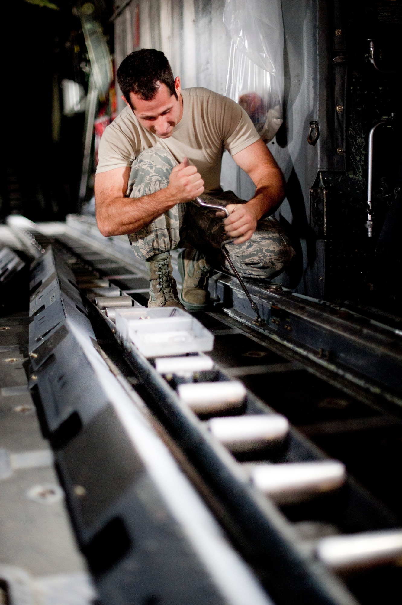 YOKOTA AIR BASE, Japan -- Staff Sgt. Christian Petersen, 374th Aircraft Maintenance Squadron, removes rail mount bolts prior to an isochronal inspection Sept. 25, 2012, at Yokota Air Base, Japan.  There are approximately 124 bolts securing the rails to the aircraft. (U.S. Air Force photo by Staff Sgt. Stacy Moless)