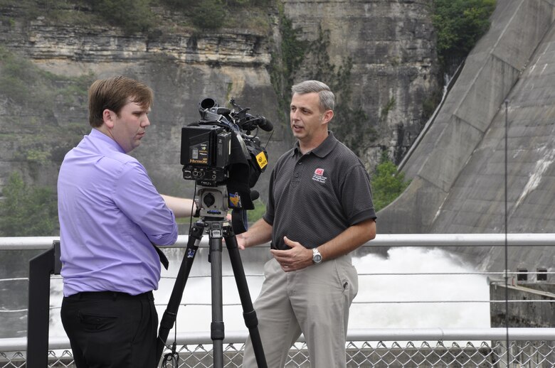 Tim Dunn, right, operations project manager for the mid-Cumberland area, U.S. Army Corps of Engineers Nashville District, explains why the Corps is having guided tours of the Center Hill Lake power plant during an interview with NBC News Channel 4 reporter and videographer Forrest Sanders July 21, 2012. (USACE photo by Fred Tucker)