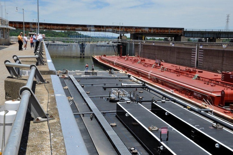 Visitors in left background observe one fuel barge easing alongside another to pass through the U.S. Army Corps of Engineers Nashville District’s Lake Barkley Lock together June 23, 2012. Public access to this area had been restricted since the 9-11 terrorist attacks. (USACE photo by Fred Tucker)