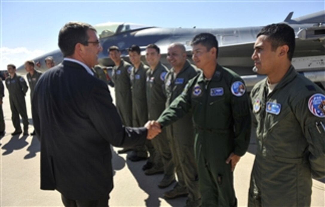 Deputy Secretary of Defense Ashton B. Carter shakes hands with F-16 Fighting Falcon training students from several nations while visiting the 162nd Fighter Wing at the Tucson International Airport in Arizona, on Sept. 26, 2012.  Carter and his staff met with students and exchange pilots from Iraq, Singapore, Japan, Denmark, Poland, South Korea, Norway and the Netherlands.  