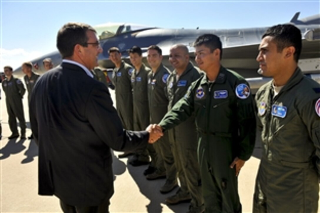 Deputy Defense Secretary Ashton B. Carter, left foreground, shakes hands with multinational F-16 Fighting Falcon aircraft training students while visiting the Air Force's 162nd Fighter Wing at the Air National Guard Base on Tucson International Airport,  Tucson, Ariz., Sept. 26, 2012. 