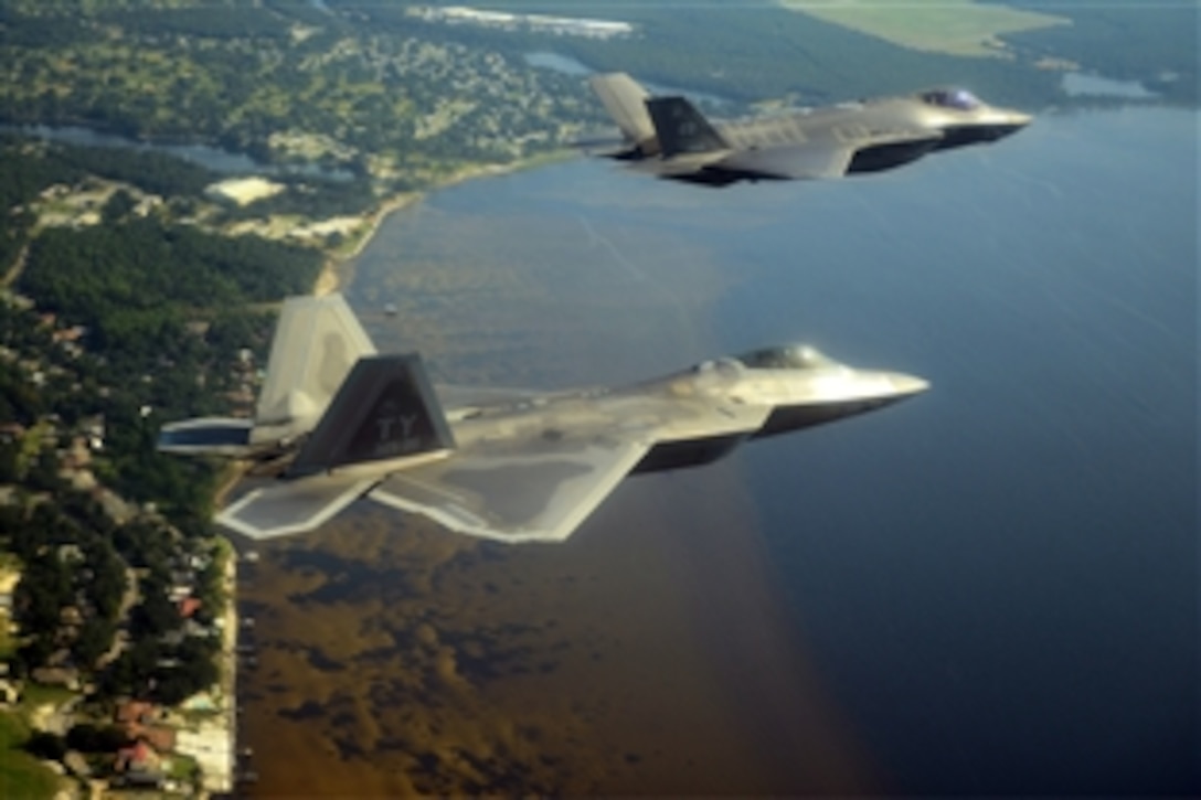 An F-35A Lightning II joint strike fighter from the 33rd Fighter Wing at Eglin Air Force Base, Fla., and an F-22A Raptor from the 325th Fighter Wing at Tyndall Air Force Base, Fla., soar over the Emerald Coast Sept. 19, 2012. The flight marked  the first time the two fifth-generation fighters have flown together for the Air Force.
