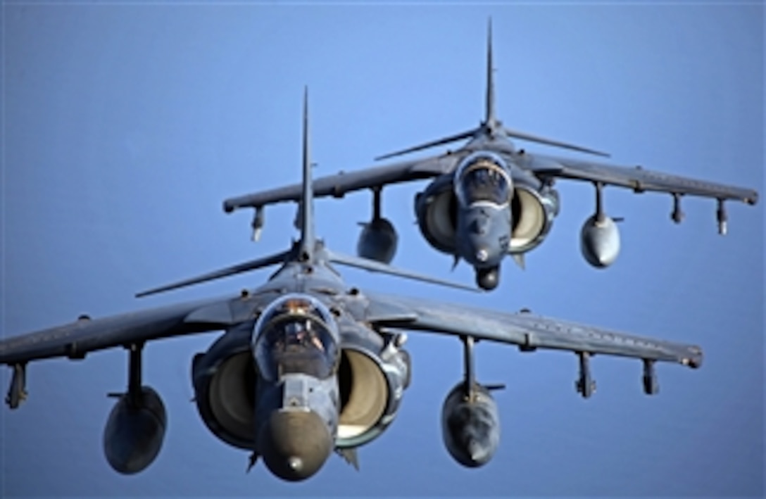 Two U.S. Marine Corps AV-8 Harriers fly in formation after conducting aerial refueling training on Sept. 23, 2012.  MV-22B Ospreys and AV-8B Harriers are conducting aerial refueling with the KC-130J Hercules planes to practice the skills needed for long-range flight operations.  The aircraft are part of the 24th Marine Expeditionary Unit, which is deployed with the Iwo Jima Amphibious Ready Group.  