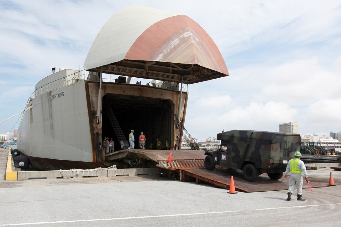 A Marine drives a Humvee aboard the integrated tug and barge vessel Thunder/Lightning at Naha Military Port Sept. 23. Marines with various III Marine Expeditionary Force units worked with contractors from Okinawa Marine Services and Foss International to load equipment for the upcoming bilateral Amphibious Landing Exercise 2013 in the Republic of the Philippines. 