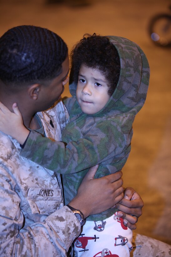 Sgt. Christian L. Jones, the career planner for Marine Tactical Electronic Warfare Squadron 3, says a final farewell to his wife and sons before loading up on the bus outside his unit's hangar aboard Cherry Point, Sept. 25. Jones and more than 100 Marines left on a seven-month deployment to Central Command to replace their sister unit VMAQ-2, in support of operations in Afghanistan.