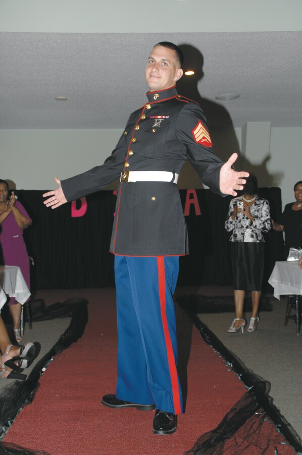 Sgt. Edward Peifer hams it up on the red carpet at the first Divas’ Ball in Camilla, Ga., Sept. 8. He was among nine Marine Corps Logistics Base Albany and Marine Corps Logistics Command Marines who served as escorts and ushers. The Majestic Kingdom Embassy hosted the event to honor women from the region who have overcome adversities.  Marines assisted the women as they walked the red carpet while an emcee shared their stories.  As a treat, the Marines also walked the red carpet as the attendees snapped photos.