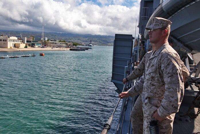 Marines from the 15th Marine Expeditionary Unit watch as the USS Rushmore leaves U.S. Naval Base Pearl Harbor, Hawaii, a week into the unit’s Western Pacific Deployment, Sept. 25. The MEU and Peleliu Amphibious Ready Group will continue their deployment, where they plan to conduct theater security cooperation exercises and humanitarian operations.