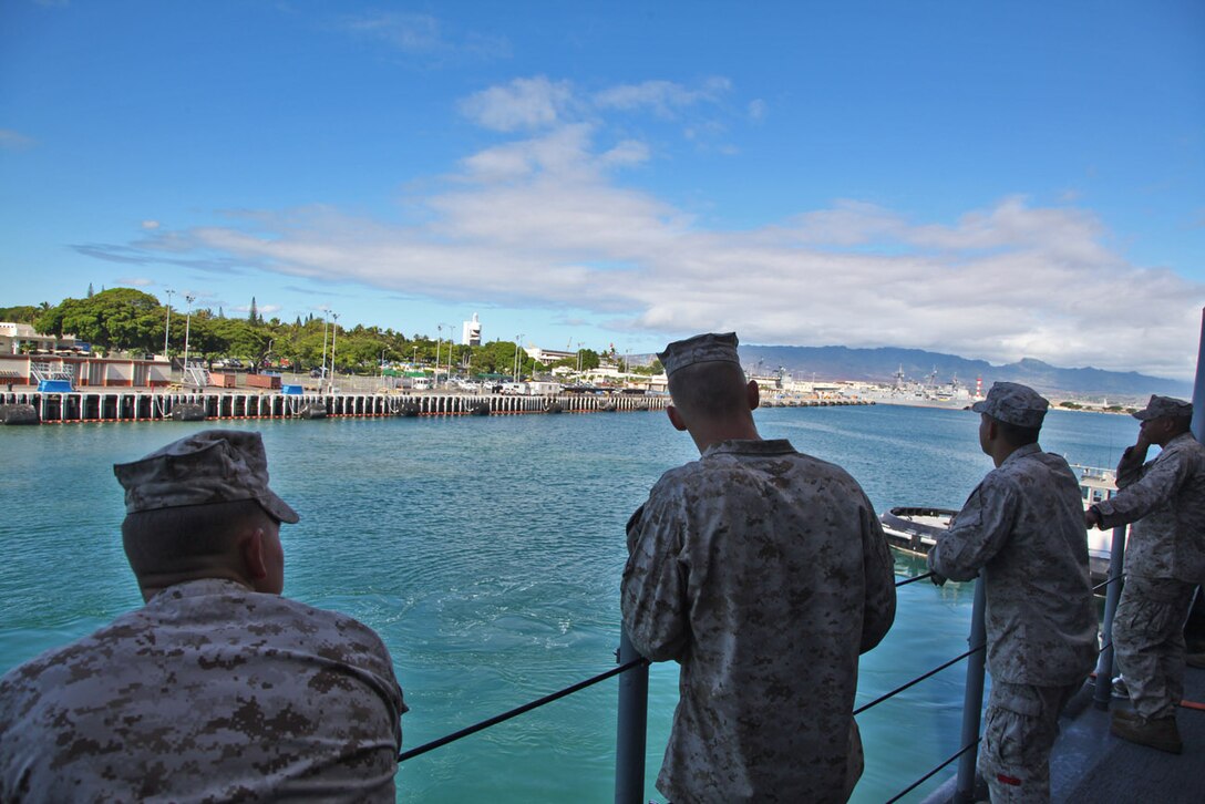 Marines from the 15th Marine Expeditionary Unit watch as the USS Rushmore leaves U.S. Naval Base Pearl Harbor, Hawaii, a week into the unit’s Western Pacific Deployment, Sept. 25. The MEU and Peleliu Amphibious Ready Group will continue their deployment, where they plan to conduct theater security cooperation exercises and humanitarian operations.