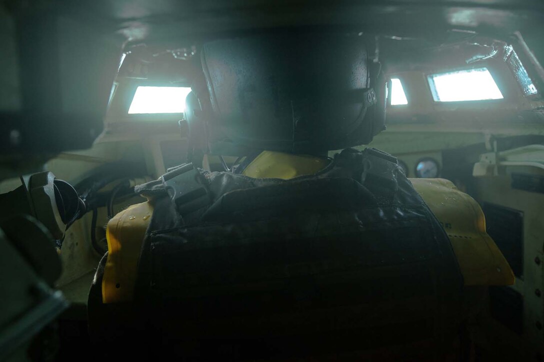 Lance Cpl. Henry Terriquez, an Amphibious Assault Vehicle crewman, with 3rd Assault Amphibian Battalion, 1st Marine Division, drives an AAV during a mock ship to shore operation aboard the USS Makin Island September 6.