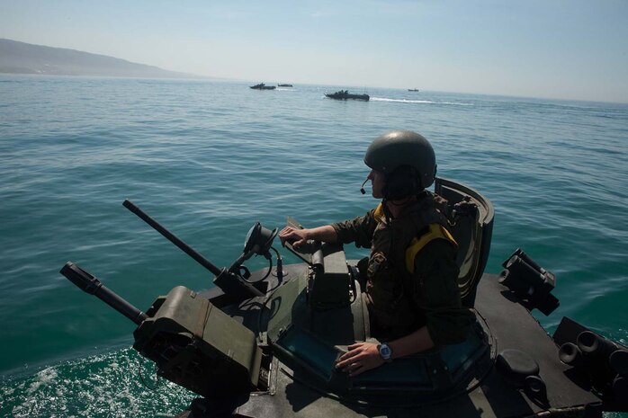 Sgt. Garrett Baresel, an Amphibious Assault Vehicle crewman, with 3rd Assault Amphibian Battalion, 1st Marine Division, commands his vehicle and crew during a mock ship to shore operation aboard the USS Makin Island September 6.