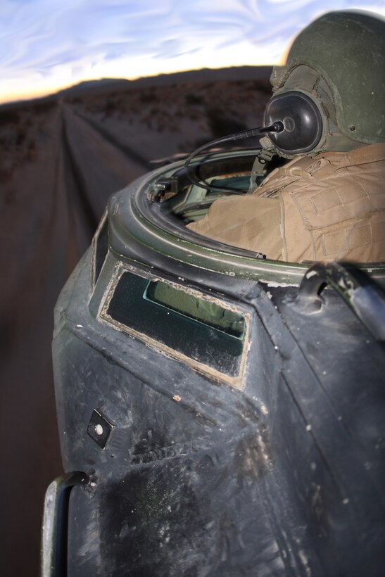 Cpl. Zachary Endsley, an Amphibious Assault Vehicles crew chief and driver with Company D, 3rd Assault Amphibian Battalion, hurries to get in position during an assault Dec. 10 at the Combat Center's Acorn Training Area.