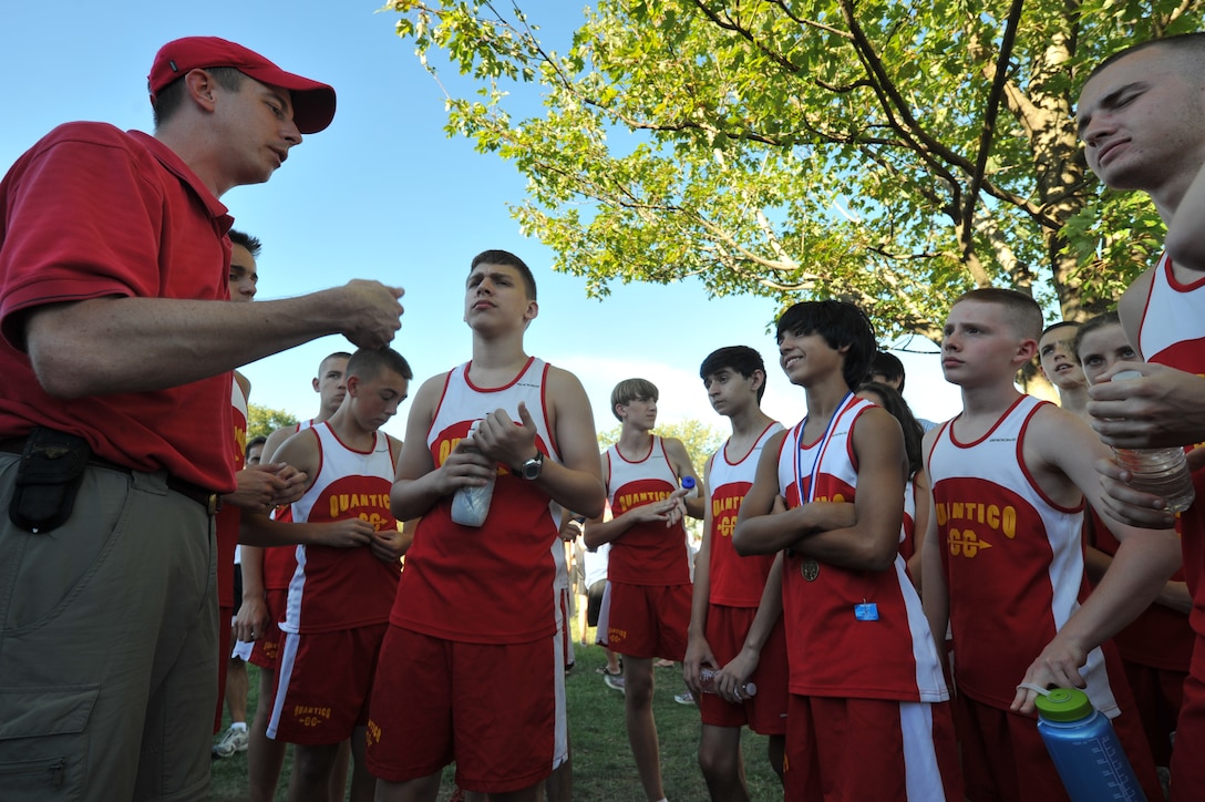 Joshua Thom, Quantico Middle/High School cross country coach, talks to his team about the results of the race during their cross country invitational at John H. Russell Elementary School on Sept. 11. More than 150 runners were a part of the invitational this year.
