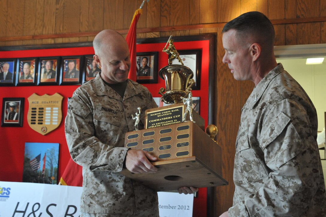 Col. David Maxwell, Marine Corps Base Quantico commander, presents Col. J. C. Brennan, Headquarters and Service Battalion commanding officer, with the 2012 Commander’s Cup at Lejeune Hall on Sept. 12. H&S Bn., took first place out of 37 MCB Quantico organizations in the competition.
