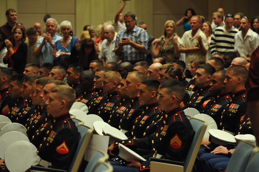 Marines keep their bearing and composure as their family and friends give them a standing ovation during the Marine Security Guard School graduation ceremony on Aug. 14. More than 150 friends, family and fellow Marines came to support their Marine.