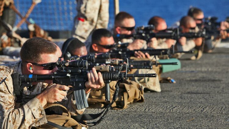 Servicemembers from Combat Logistics Battalion 15, 15th Marine Expeditionary Unit, sight-in on targets on the flight deck of the USS Rushmore, Sept. 27. During the 15th MEU and Peleliu Amphibious Ready Group?s Western Pacific deployment, the Marines and sailors decided to let loose a few rounds in order to find their battle sight zero and ensure their M16A4 and M4A1 service rifles were functioning properly.